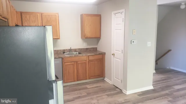 a kitchen with a refrigerator and a stove