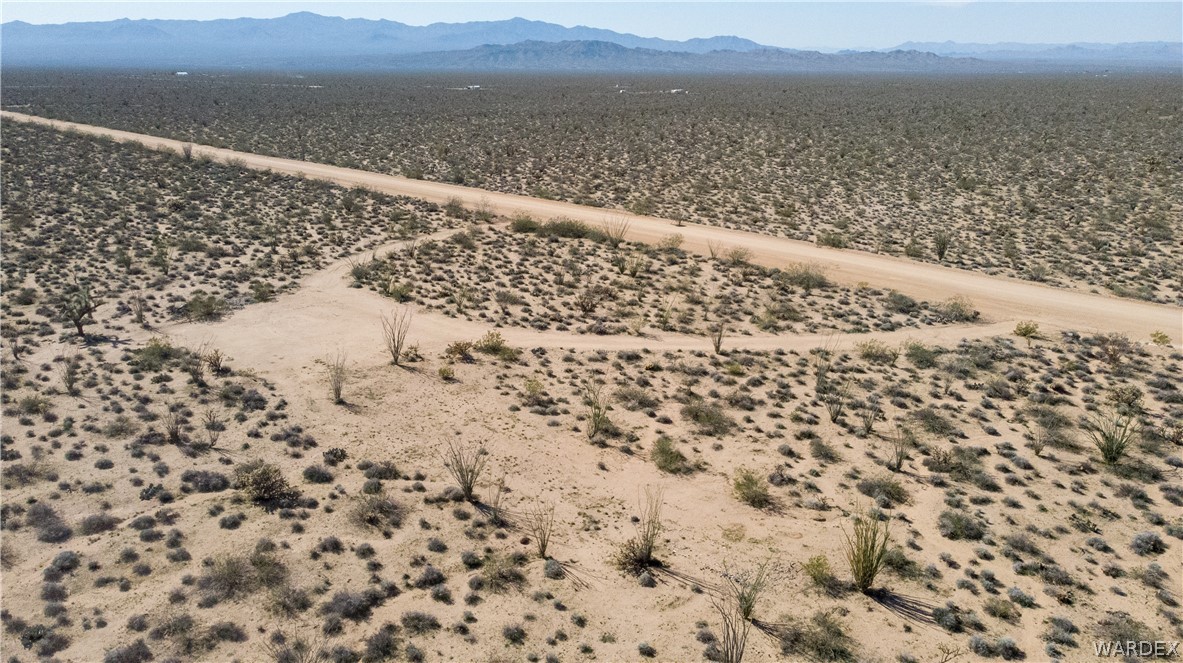 3231 South Cochise Road Yucca, AZ 86438 - Photo 3 of 16 View of rural area featuring a mountainous background and a desert landscape