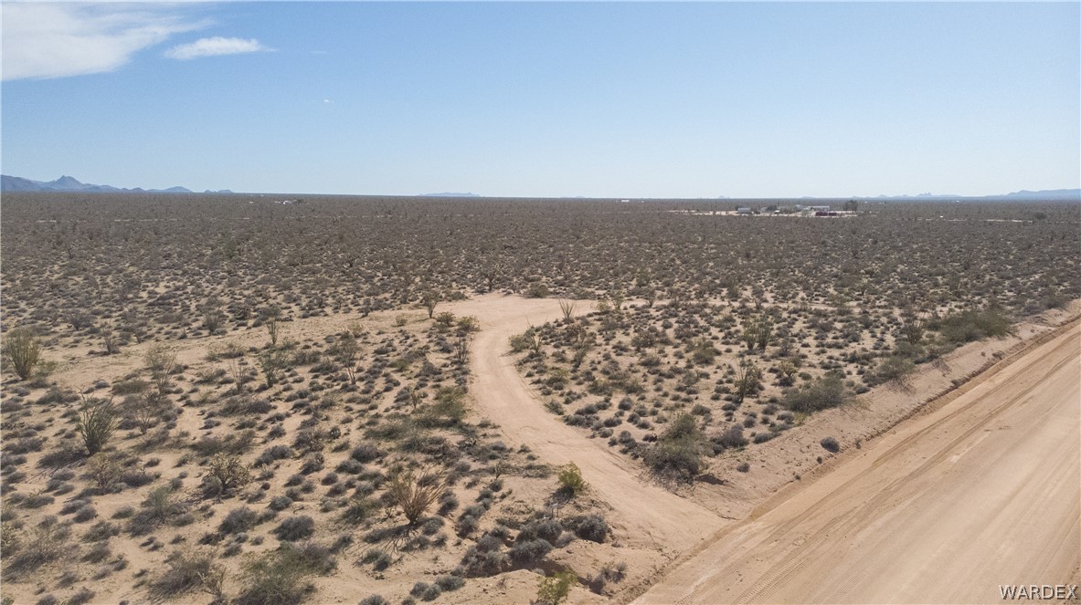 3231 South Cochise Road Yucca, AZ 86438 - Photo 6 of 16 View of rural area with a desert landscape and a mountain backdrop