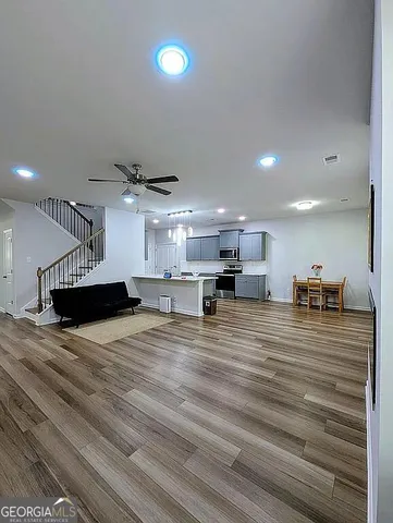 a bedroom with a bed and a ceiling fan