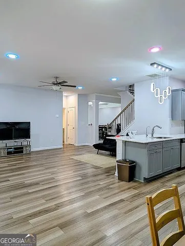 a view of a livingroom with a ceiling fan and window