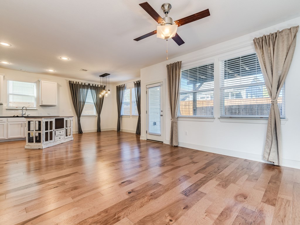 2208 Capulet Street Austin, TX 78741 - Photo 3 of 23 a view of an empty room with wooden floor and a window