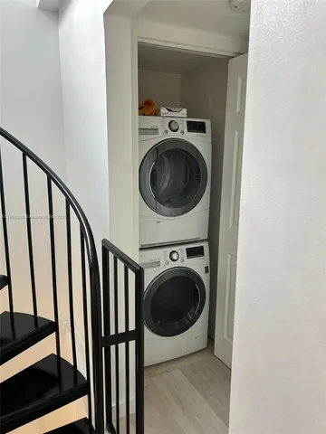 a view of a hallway with washer and dryer