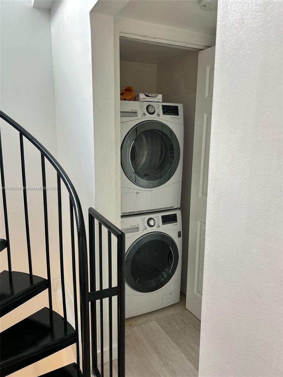 3036 Southwest 27th Avenue, Unit 5 Miami, FL 33133 - Photo 1 of 18 a view of a hallway with washer and dryer