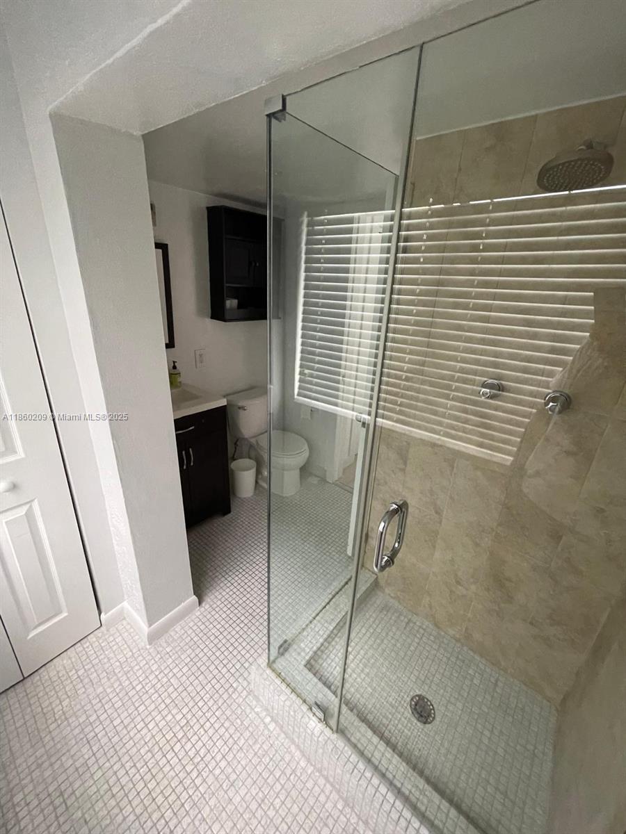 3036 Southwest 27th Avenue, Unit 5 Miami, FL 33133 - Photo 12 of 18 a bathroom with a shower and a sink