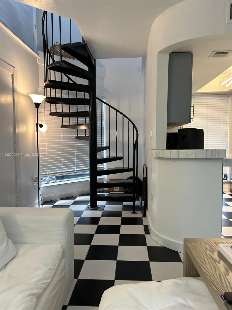 3036 Southwest 27th Avenue, Unit 5 Miami, FL 33133 - Photo 3 of 18 a view of entryway and hall with wooden floor