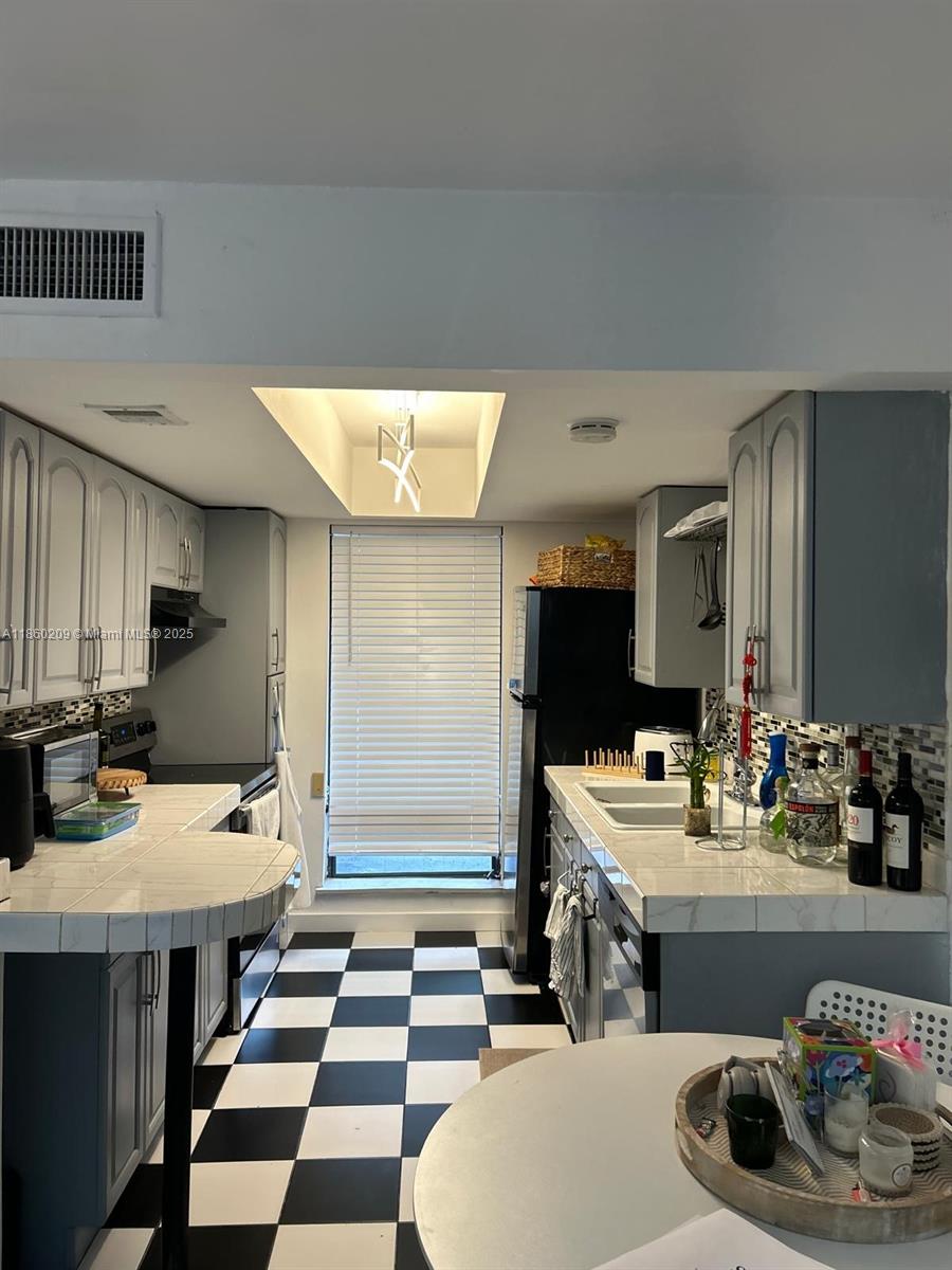 3036 Southwest 27th Avenue, Unit 5 Miami, FL 33133 - Photo 5 of 18 a room with a table chairs and view kitchen