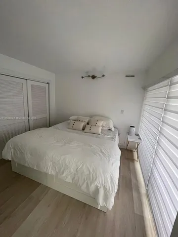 a living room with a couch and a walk in closet