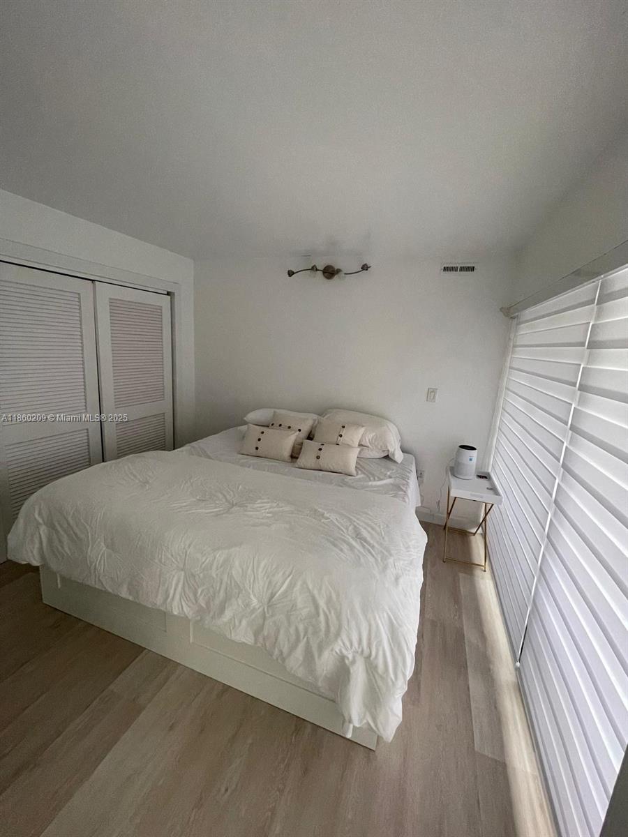 3036 Southwest 27th Avenue, Unit 5 Miami, FL 33133 - Photo 6 of 18 a bedroom with a bed and a rug