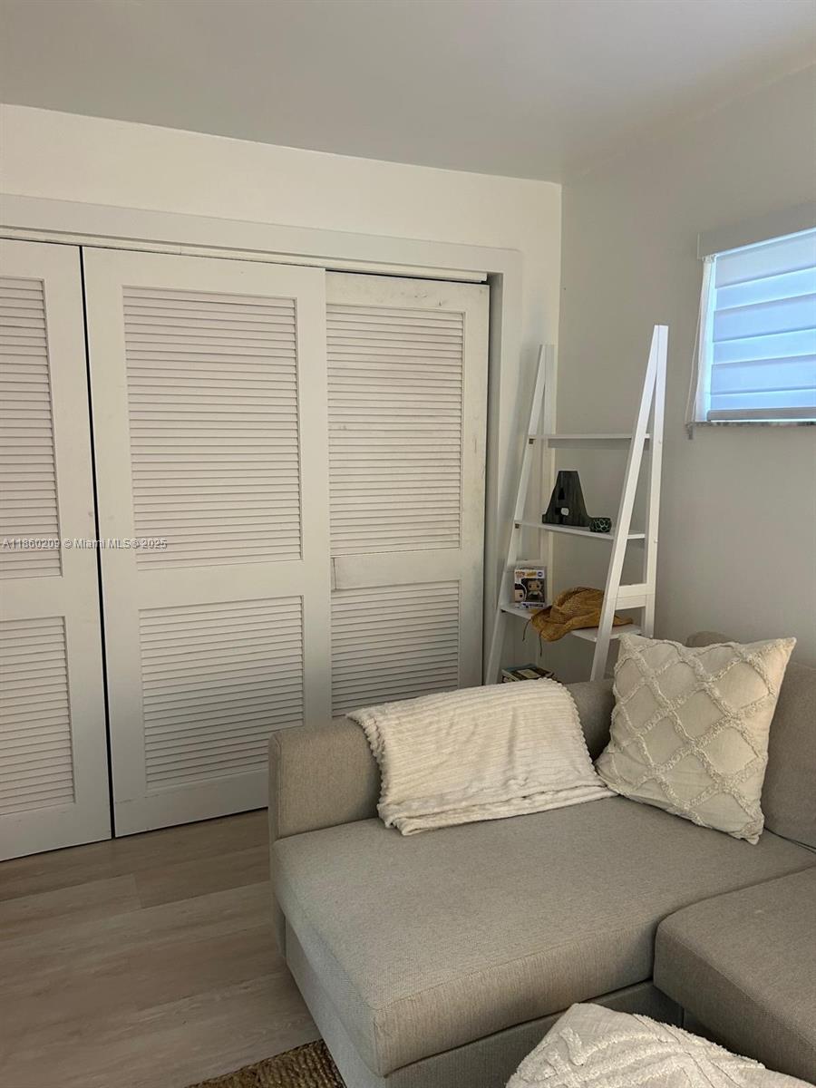 3036 Southwest 27th Avenue, Unit 5 Miami, FL 33133 - Photo 7 of 18 a living room with a couch and a walk in closet