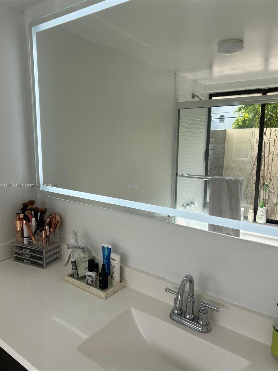 3036 Southwest 27th Avenue, Unit 5 Miami, FL 33133 - Photo 9 of 18 a kitchen with a sink and wooden floor