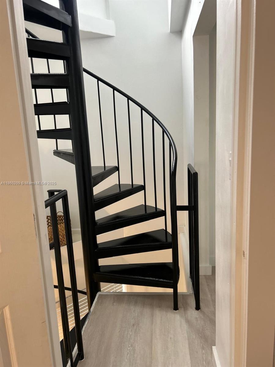 3036 Southwest 27th Avenue, Unit 5 Miami, FL 33133 - Photo 10 of 18 a view of staircase with white walls and a window
