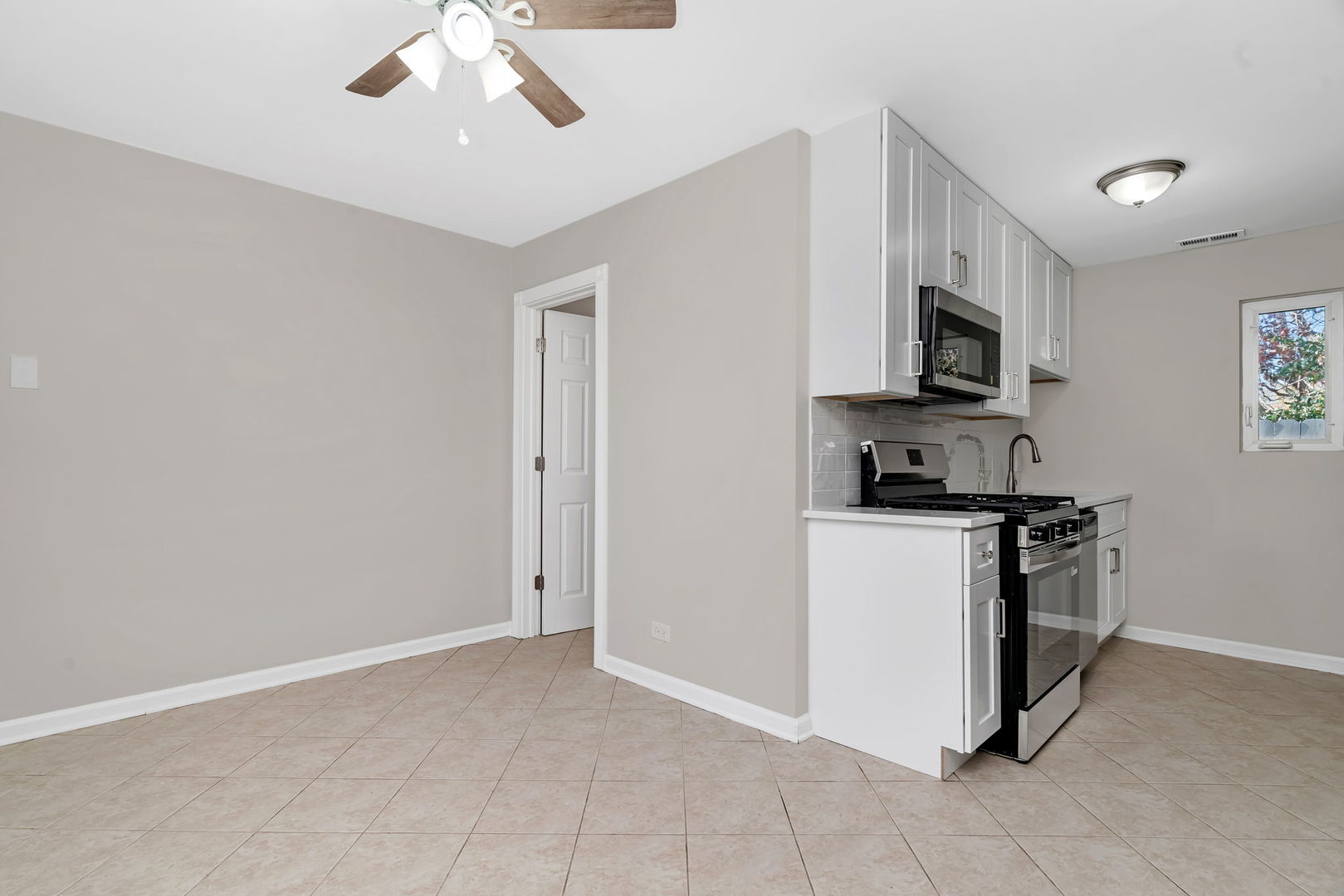 3624 151st Street Midlothian, IL 60445 - Photo 17 of 26 a kitchen with stainless steel appliances granite countertop a refrigerator a stove a microwave oven with white cabinets