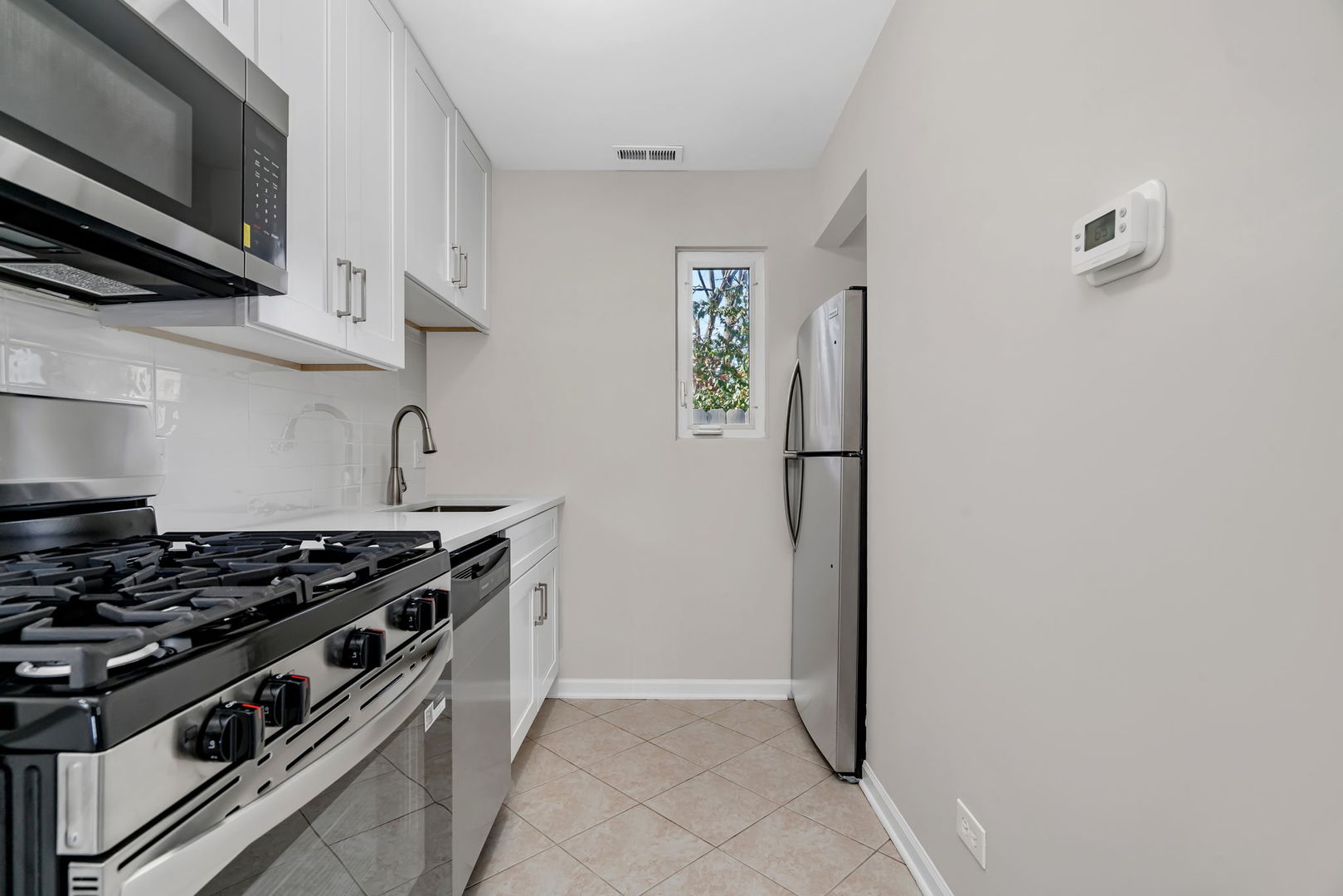 3624 151st Street Midlothian, IL 60445 - Photo 20 of 26 a kitchen with stainless steel appliances granite countertop a stove and a refrigerator