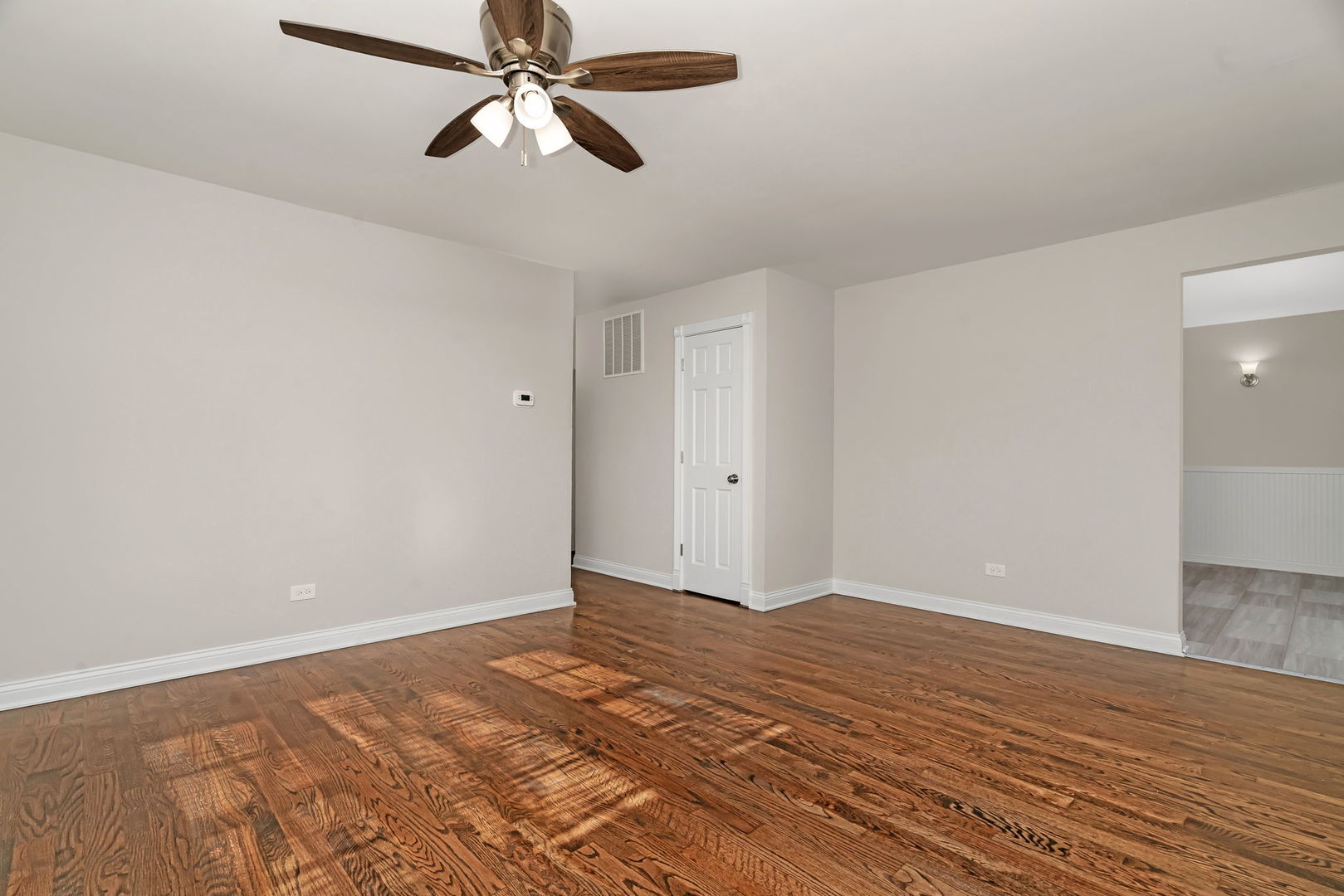 3624 151st Street Midlothian, IL 60445 - Photo 4 of 26 a view of a room with wooden floor and a ceiling fan