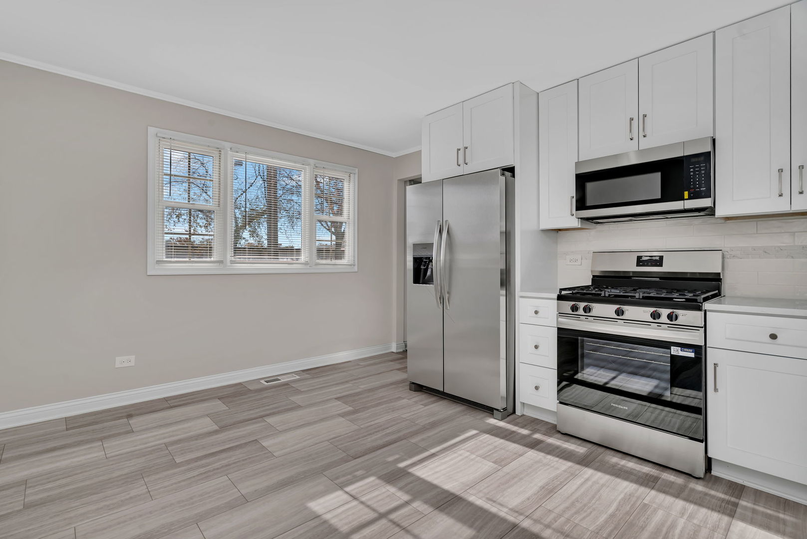 3624 151st Street Midlothian, IL 60445 - Photo 6 of 26 a kitchen with stainless steel appliances a refrigerator stove and white cabinets