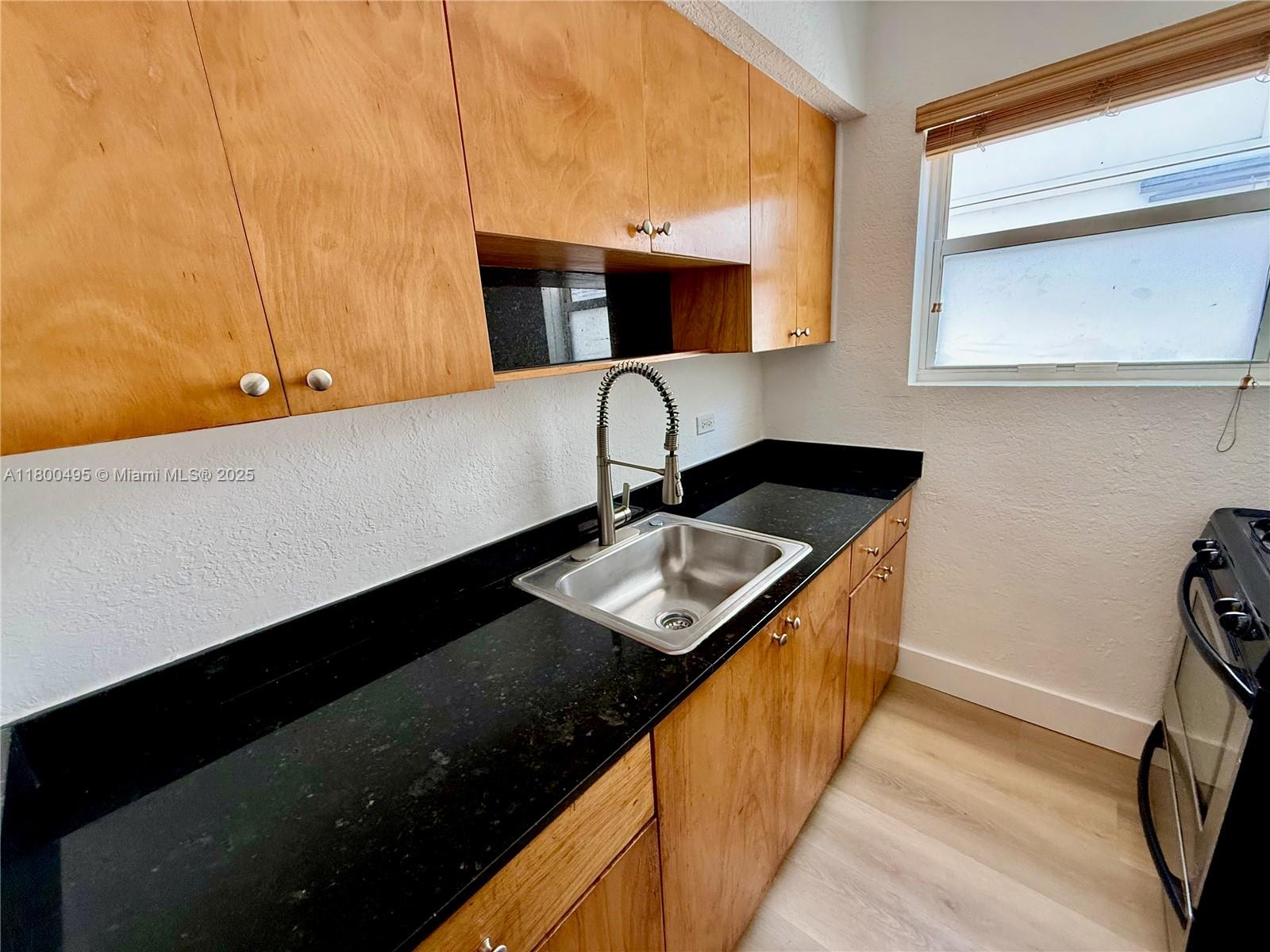 7334 Harding Avenue, Unit 3 Miami Beach, FL 33141 - Photo 15 of 23 a kitchen with a sink and a stove top oven