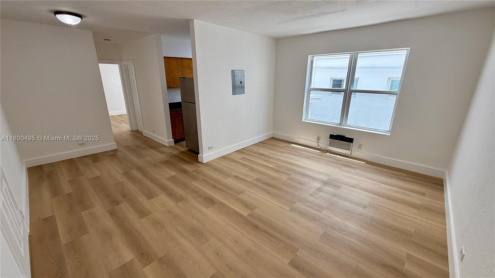7334 Harding Avenue, Unit 3 Miami Beach, FL 33141 - Photo 2 of 23 wooden floor in an empty room with a window