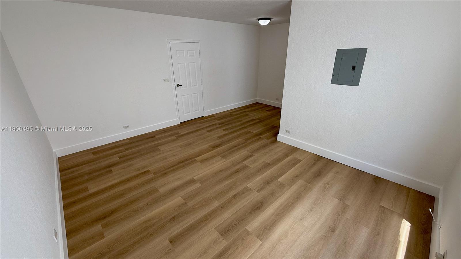 7334 Harding Avenue, Unit 3 Miami Beach, FL 33141 - Photo 6 of 23 a view of a room with wooden floor and white wall
