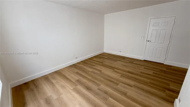 a view of room with wooden floor