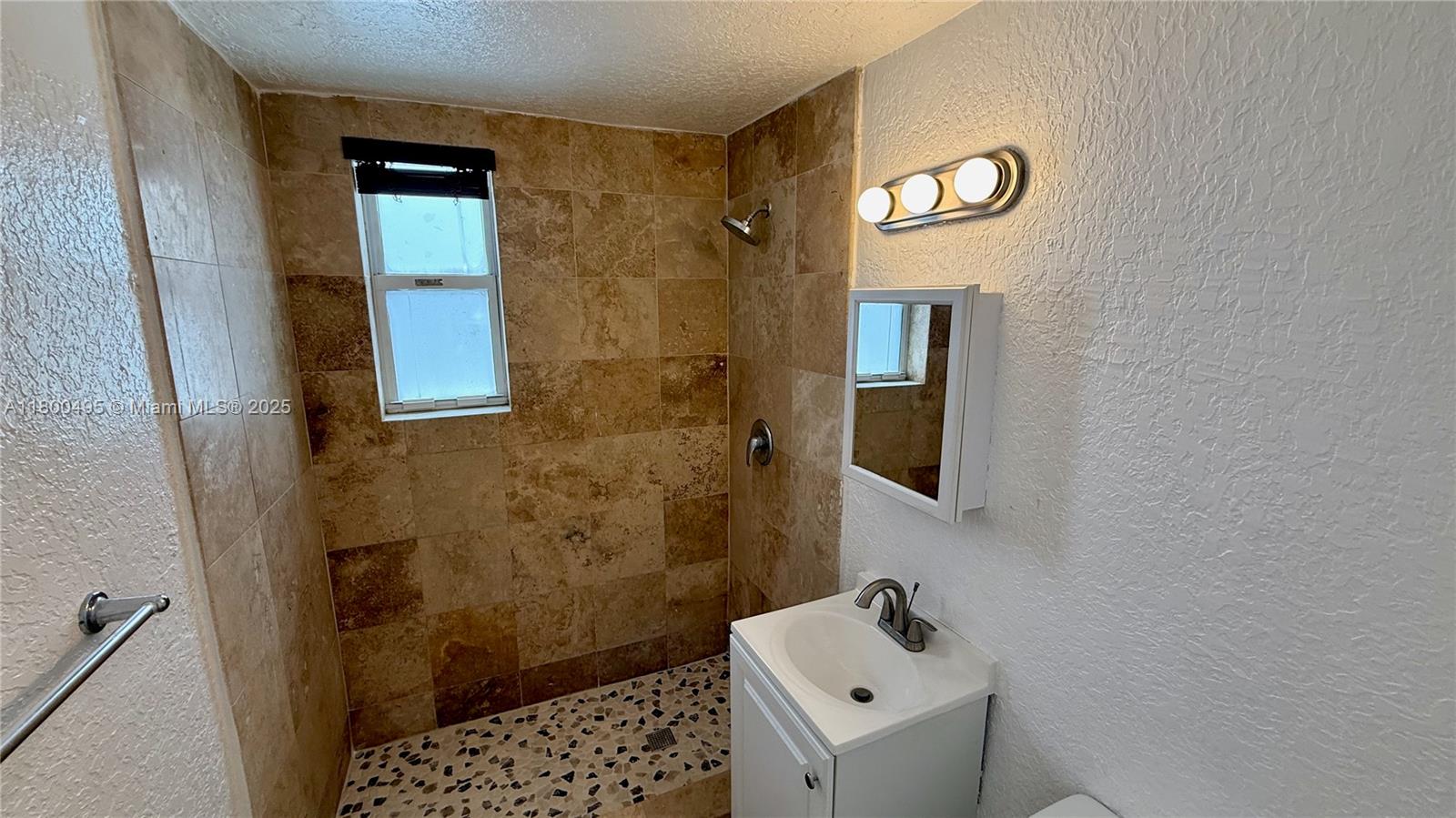 7334 Harding Avenue, Unit 3 Miami Beach, FL 33141 - Photo 9 of 23 a bathroom with a sink a toilet and shower
