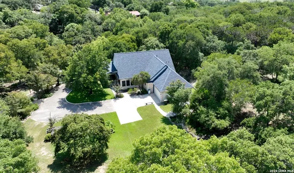 an aerial view of a house with yard swimming pool and outdoor seating
