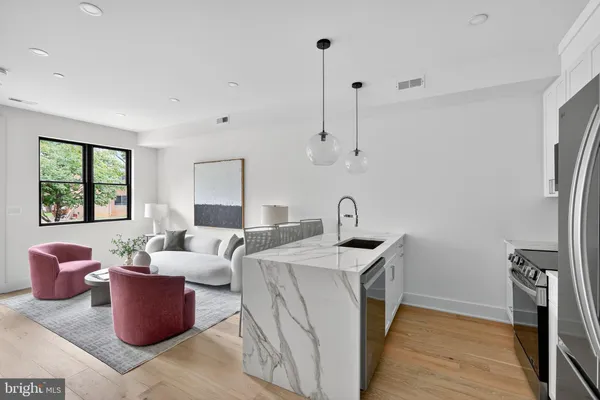 a living room with furniture a window and a wooden floor