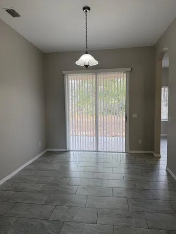 a view of an empty room with glass door