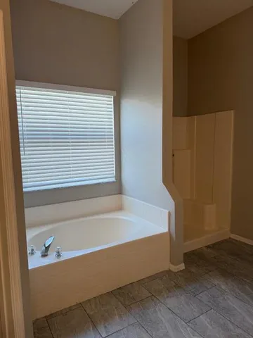 a bath tub sitting in a bathroom next to a window