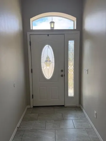 an empty room with window and a mirror