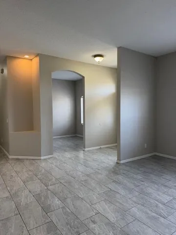 an empty room with closet and windows