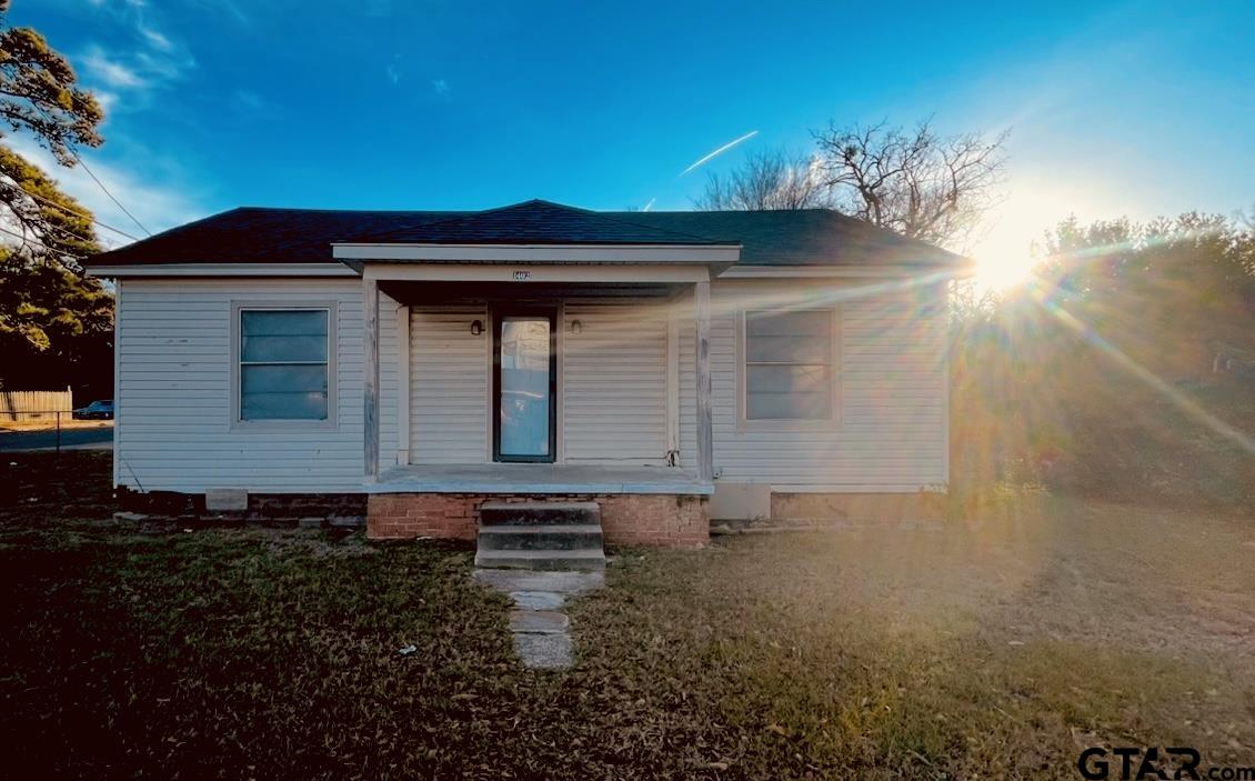 1402 Academy Tyler, TX 75701 - Photo 1 of 14 a front view of a house with a yard