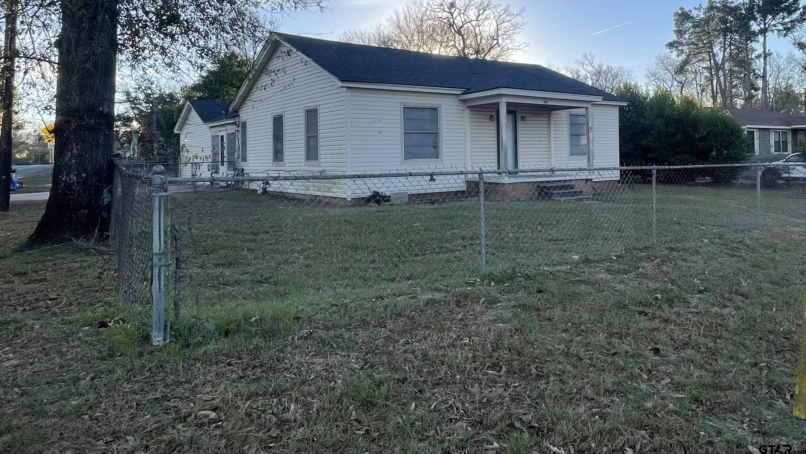 1402 Academy Tyler, TX 75701 - Photo 2 of 14 a front view of a house with garden