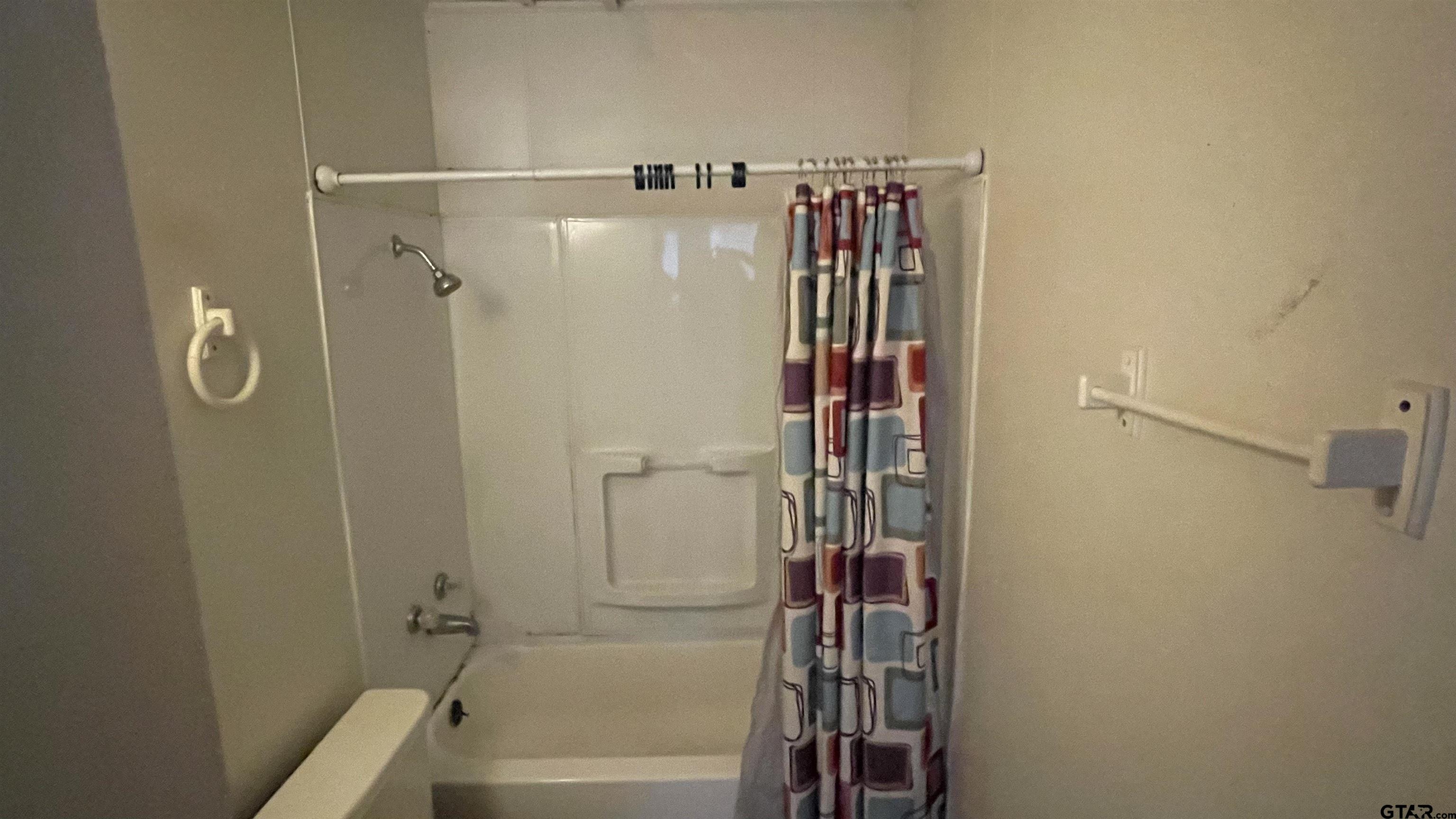 1402 Academy Tyler, TX 75701 - Photo 4 of 14 a bathroom with a shower and a tub