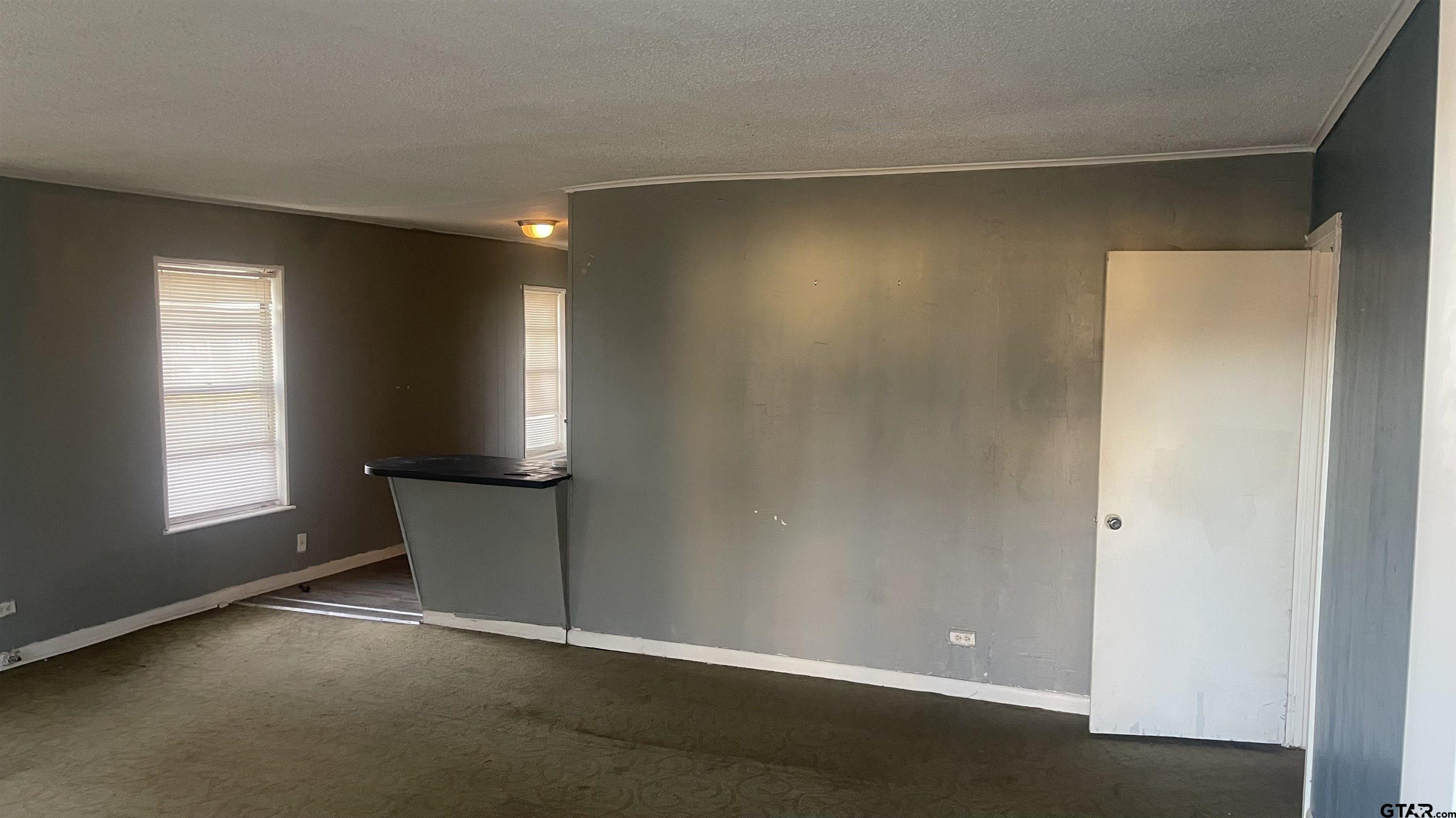 1402 Academy Tyler, TX 75701 - Photo 7 of 14 an empty room with windows and closet