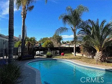 a view of a swimming pool with a table and chairs