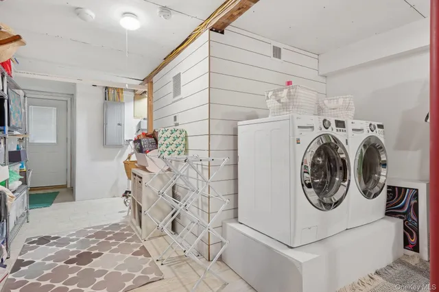 a view of a storage & utility room with a washer dryer