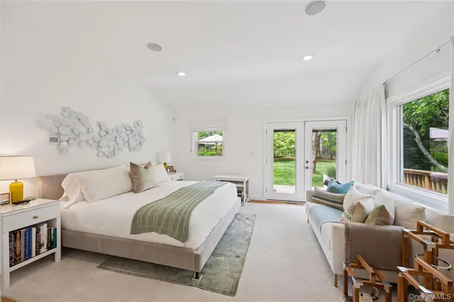 a spacious bedroom with a bed and wooden floor