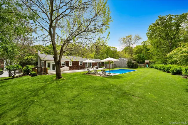 a view of yard with swimming pool and green space