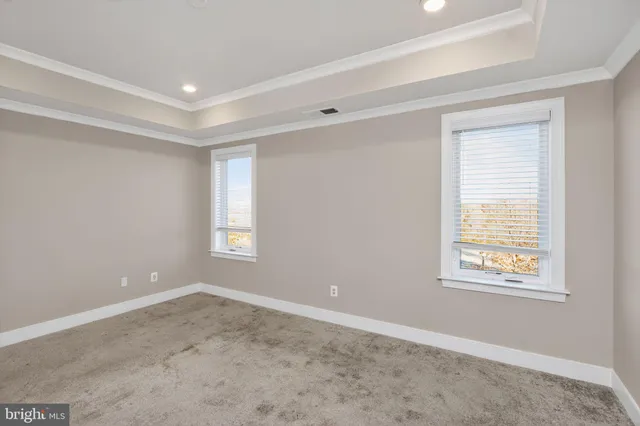 a view of wooden floor and windows in a room