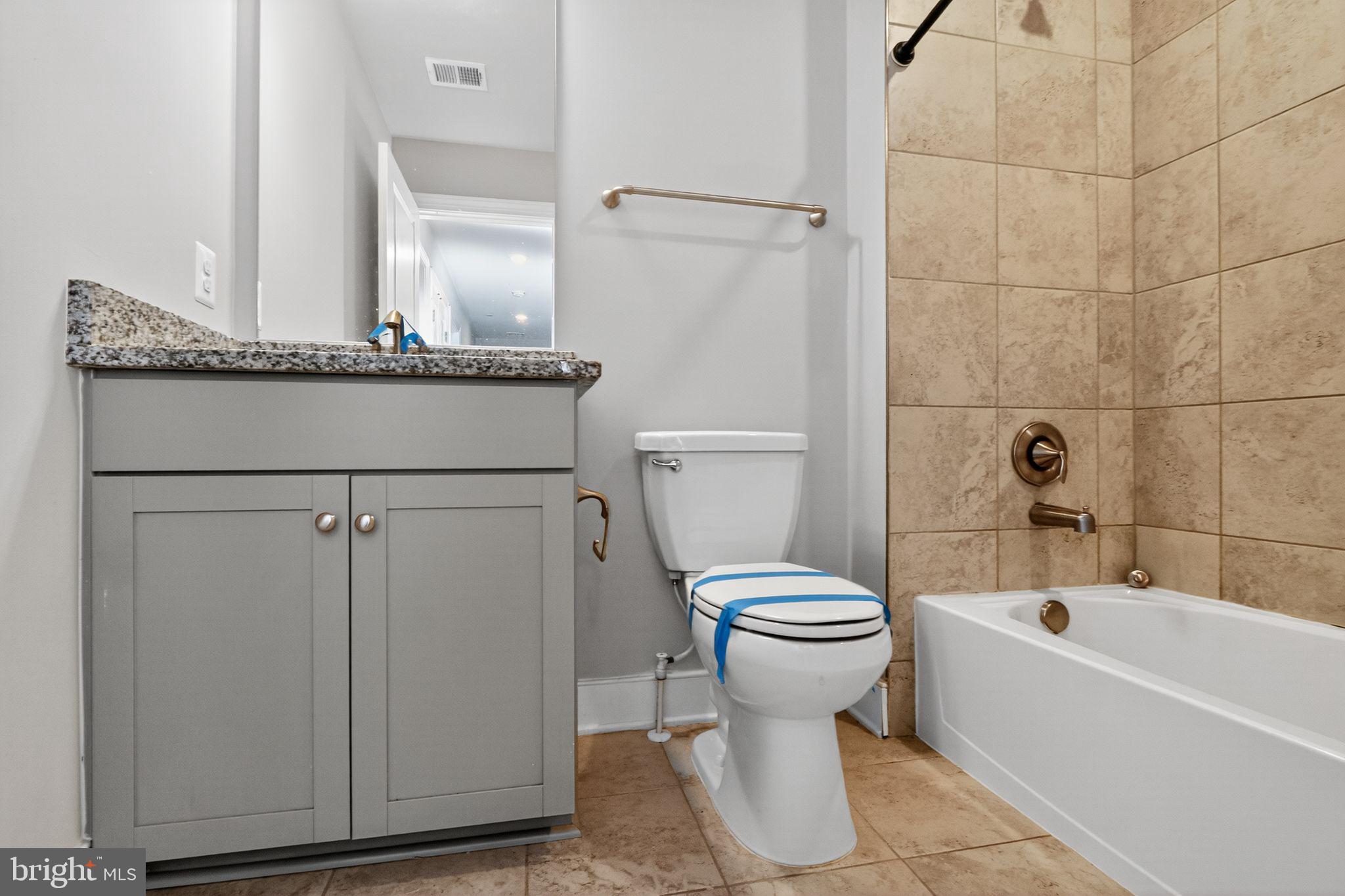 1322 Rail Woodbridge, VA 22191 - Photo 19 of 30 a bathroom with a granite countertop toilet sink and mirror