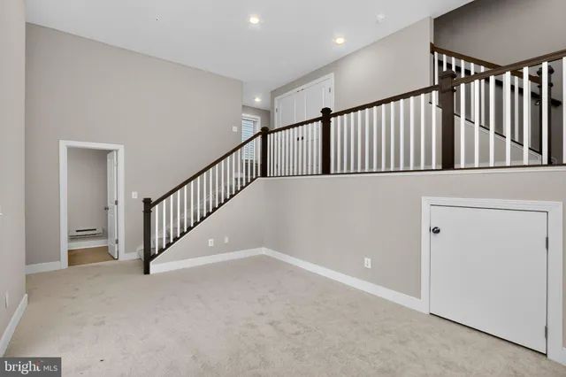 a view of staircase with lots of frames on wall