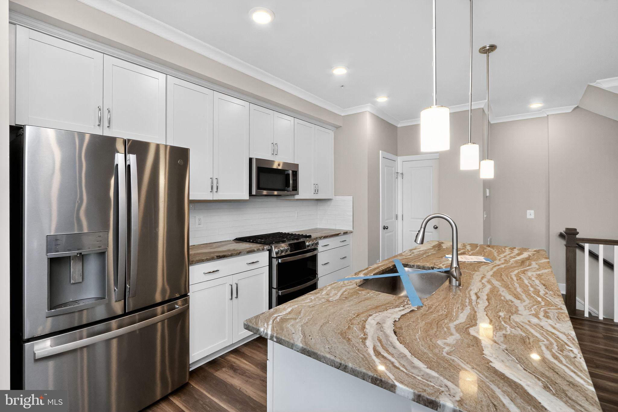 1322 Rail Woodbridge, VA 22191 - Photo 7 of 30 a kitchen with kitchen island a counter space a sink appliances and cabinets