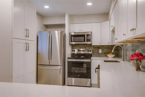 a kitchen with a refrigerator and a sink