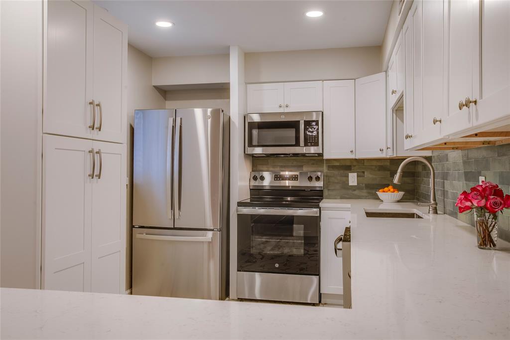 7777 Royal Lane Dallas, TX 75230 - Photo 11 of 30 a kitchen with a refrigerator and a sink