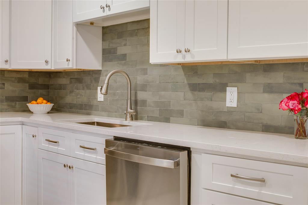 7777 Royal Lane Dallas, TX 75230 - Photo 14 of 30 a kitchen with stainless steel appliances granite countertop white cabinets and a potted plant