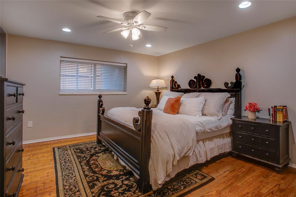 7777 Royal Lane Dallas, TX 75230 - Photo 15 of 30 a bed room with a bed and a chandelier
