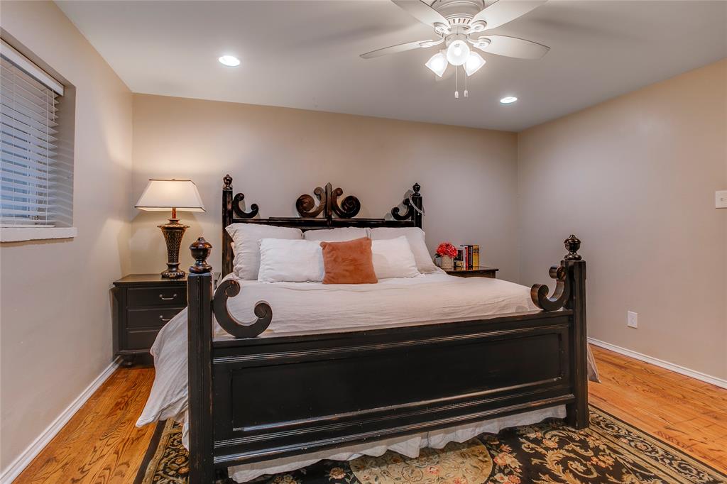 7777 Royal Lane Dallas, TX 75230 - Photo 16 of 30 a bed room with a bed and a lamp