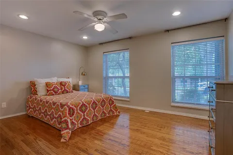 a bedroom with a large bed window and a chandelier