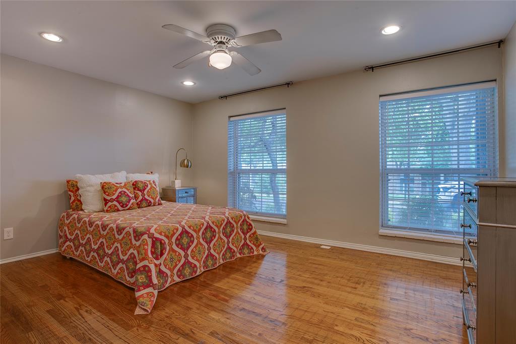 7777 Royal Lane Dallas, TX 75230 - Photo 18 of 30 a bedroom with a large bed window and a chandelier